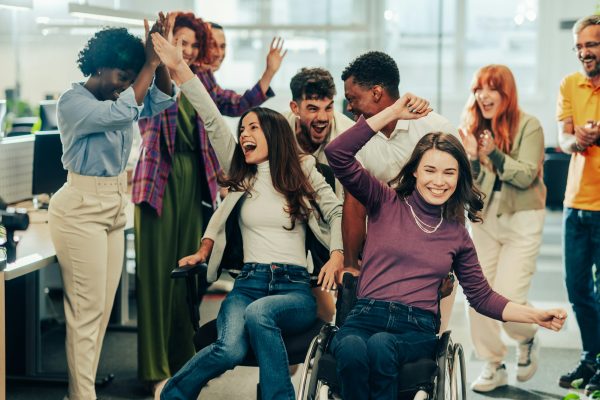 Diverse inclusive business people making a break while office chair racing